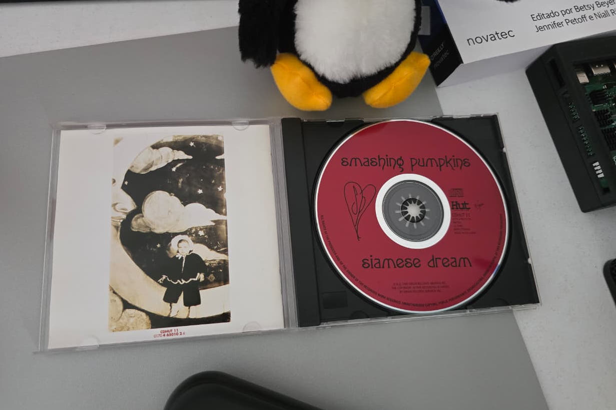 Open Siamese Dream CD case: the red disc and the sepia booklet art of a child standing on a crescent moon