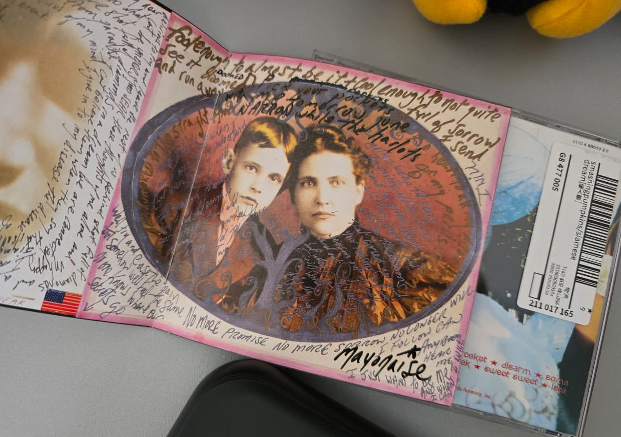 Siamese Dream booklet page with handwritten Mayonaise lyrics around an old portrait of two people